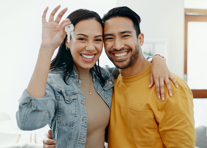 Smiling couple with house keys